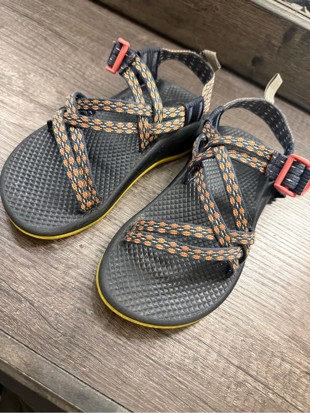 Chaco Kids Black Sandals with Orange Patterned Straps and Yellow Trim
